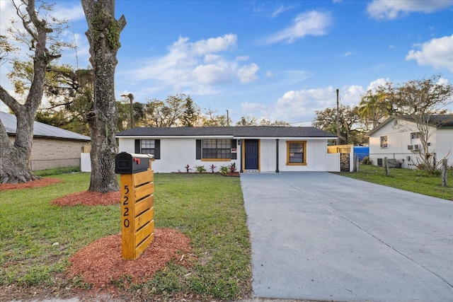 view of front of home with a front lawn and fence