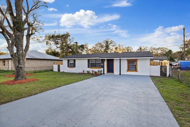 single story home with fence and a front lawn