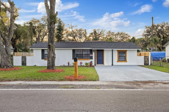 view of front of property with a front lawn and fence