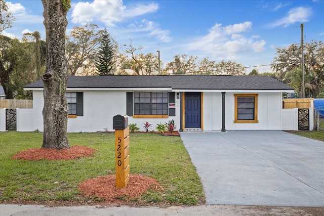 single story home with a shingled roof, fence, a front lawn, and board and batten siding