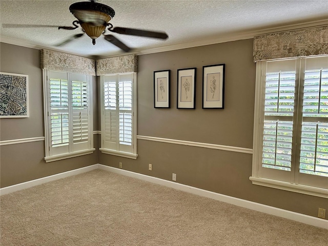 unfurnished room featuring carpet flooring, a textured ceiling, baseboards, and ornamental molding