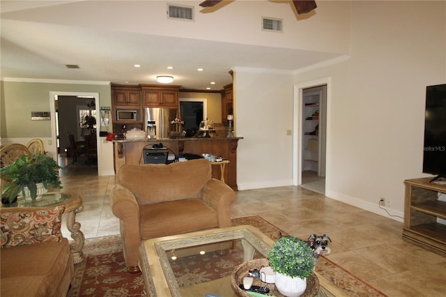 living area featuring visible vents, ceiling fan, and ornamental molding