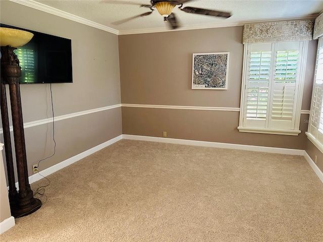 spare room with crown molding, baseboards, carpet flooring, a textured ceiling, and a ceiling fan