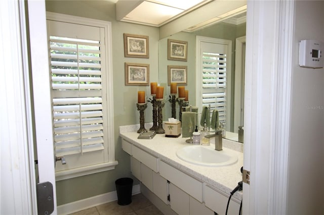 bathroom with tile patterned floors, baseboards, and vanity