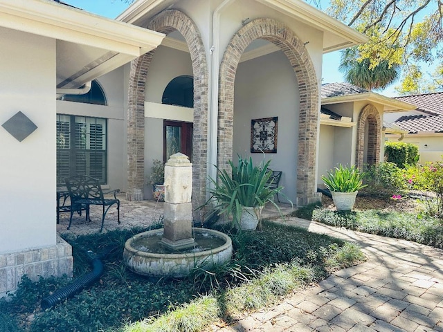 view of exterior entry with stucco siding