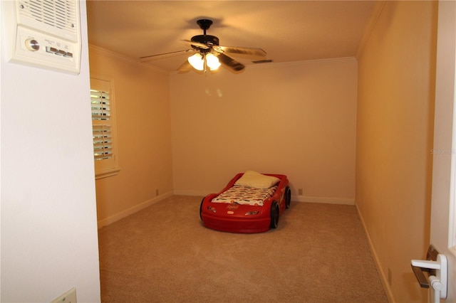 unfurnished bedroom featuring crown molding, carpet flooring, baseboards, and ceiling fan