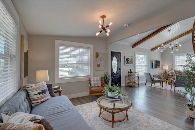 315 40th St S, Saint Petersburg, FL 33711 - living room featuring lofted ceiling with beams, baseboards, wood finished floors, and a notable chandelier