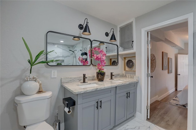 315 40th St S, Saint Petersburg, FL 33711 - bathroom featuring toilet, marble finish floor, baseboards, and a sink