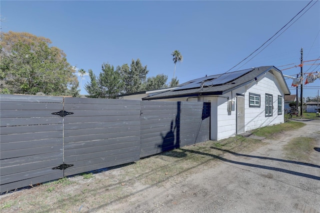 315 40th St S, Saint Petersburg, FL 33711 - view of home's exterior featuring a fenced backyard and roof mounted solar panels