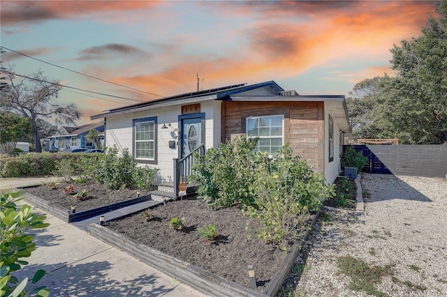315 40th St S, Saint Petersburg, FL 33711 - view of front facade featuring solar panels and fence