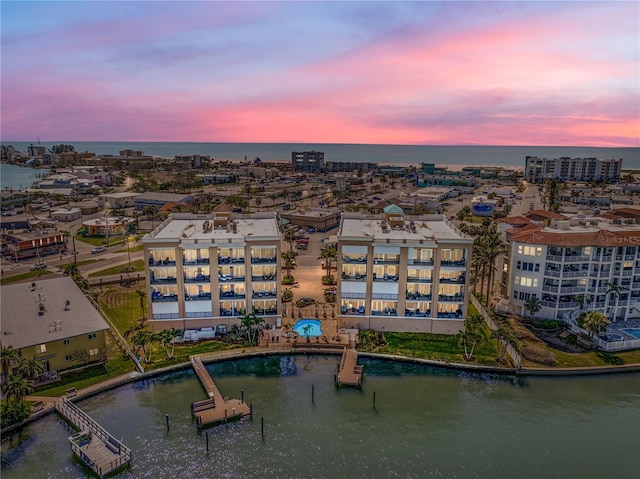 birds eye view of property with a view of city and a water view