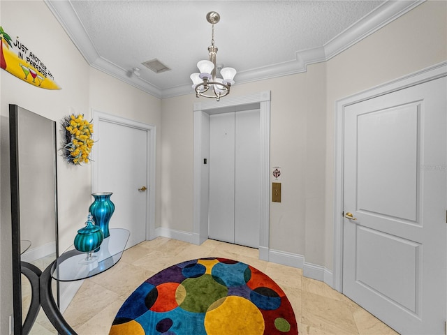 foyer with a chandelier, a textured ceiling, baseboards, ornamental molding, and elevator