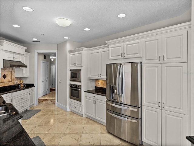 kitchen with stainless steel appliances, tasteful backsplash, white cabinetry, and under cabinet range hood