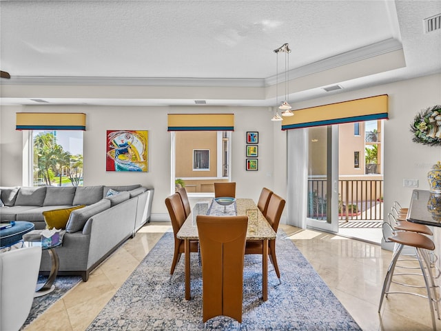 tiled dining space with crown molding, a raised ceiling, and a textured ceiling