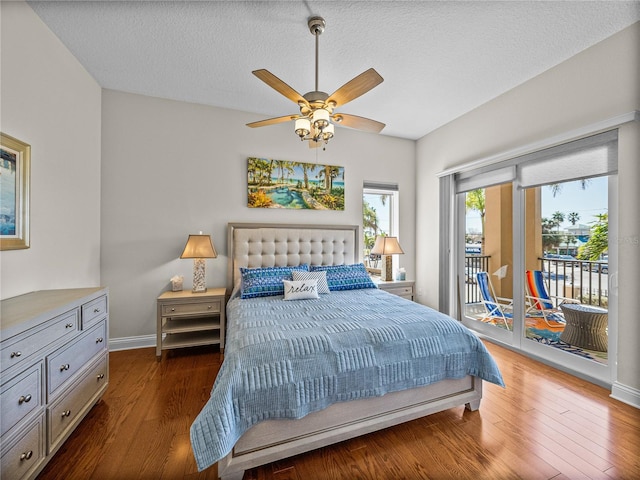 bedroom featuring a ceiling fan, a textured ceiling, wood finished floors, access to outside, and baseboards