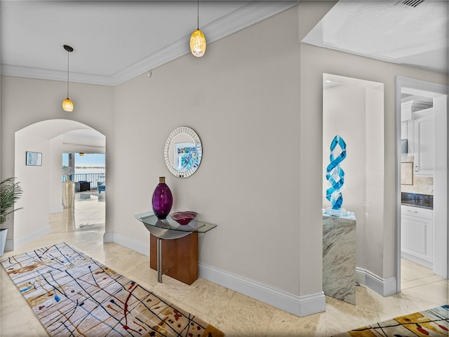 240 108th Ave Unit 102, Treasure Island, FL 33706 - hallway with arched walkways, crown molding, and light marble finish floors
