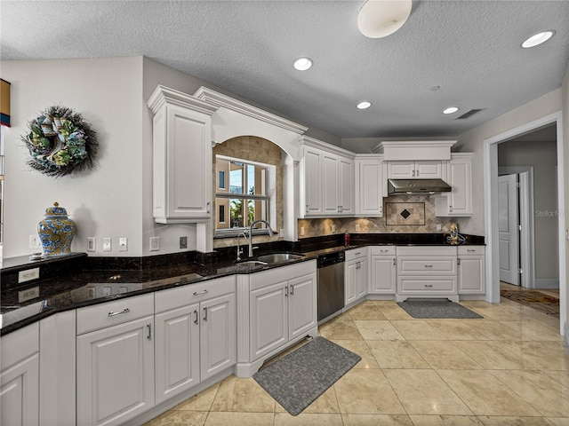 240 108th Ave Unit 102, Treasure Island, FL 33706 - kitchen with stainless steel dishwasher, white cabinetry, under cabinet range hood, a textured ceiling, and recessed lighting