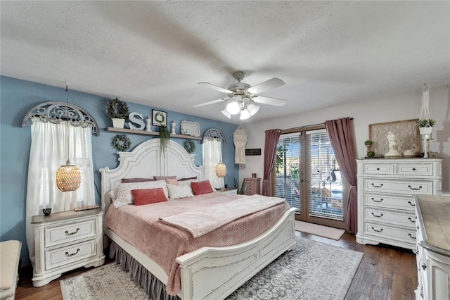 bedroom with access to exterior, a textured ceiling, a ceiling fan, and dark wood-style flooring