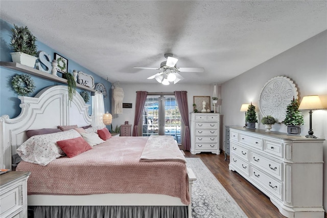 bedroom featuring a textured ceiling, ceiling fan, and dark wood-type flooring