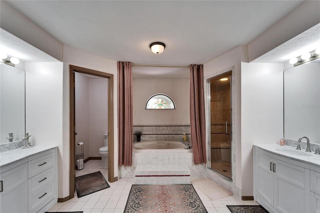 bathroom with toilet, tile patterned floors, a garden tub, vanity, and a shower stall