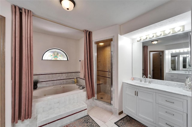 full bathroom featuring a stall shower, tile patterned flooring, a jetted tub, and vanity