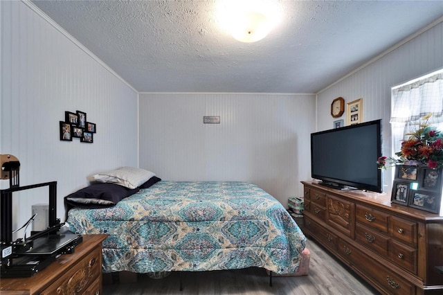 bedroom featuring a textured ceiling and wood finished floors