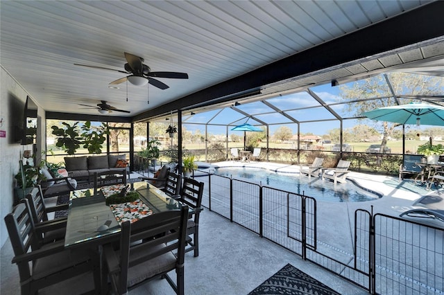 view of patio / terrace with a lanai, an outdoor pool, an outdoor hangout area, and a ceiling fan