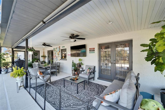 view of patio / terrace featuring an outdoor hangout area, outdoor dining area, a ceiling fan, and french doors