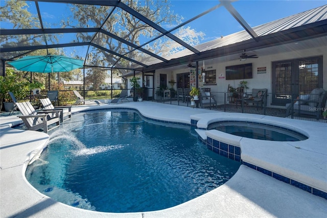 view of pool featuring glass enclosure, a ceiling fan, a patio, and french doors