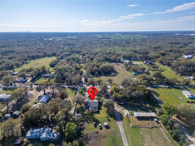 birds eye view of property with a view of trees