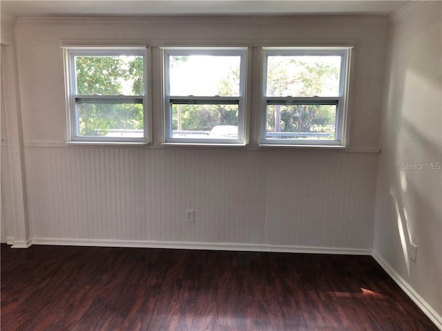 unfurnished room featuring wood finished floors and baseboards