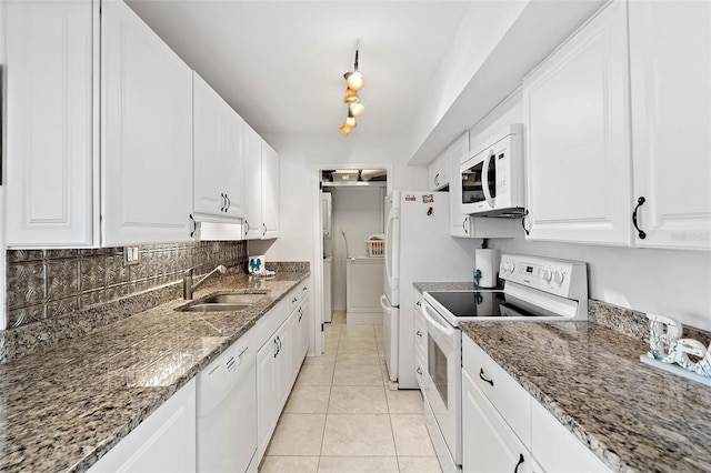 kitchen with light tile patterned floors, white cabinets, white appliances, and a sink