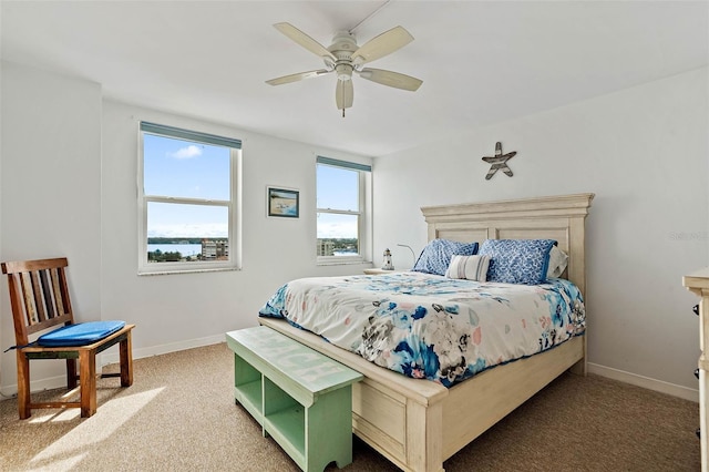 carpeted bedroom with baseboards and ceiling fan