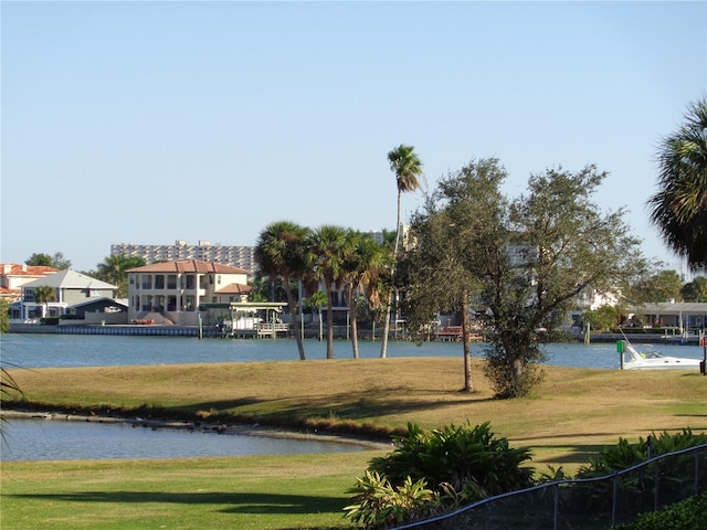 view of home's community featuring a lawn and a water view