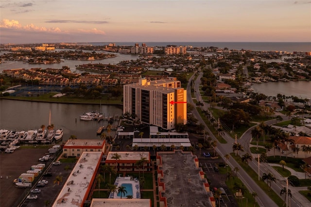 aerial view at dusk with a view of city and a water view