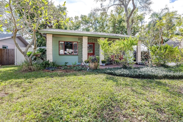 view of front of house with a front lawn and fence