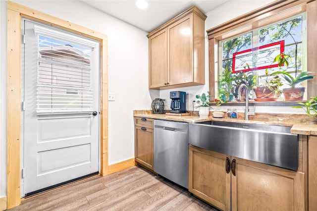 kitchen featuring light wood finished floors, baseboards, dishwasher, light brown cabinetry, and a sink