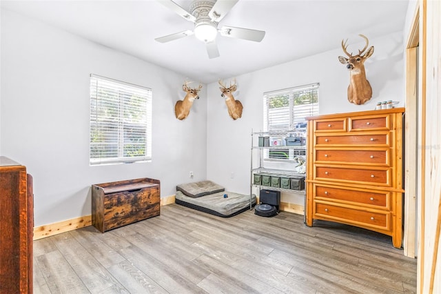 bedroom with ceiling fan, baseboards, and wood finished floors