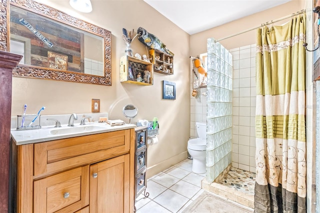 bathroom featuring baseboards, tiled shower, toilet, tile patterned flooring, and vanity