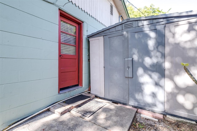 doorway to property featuring concrete block siding