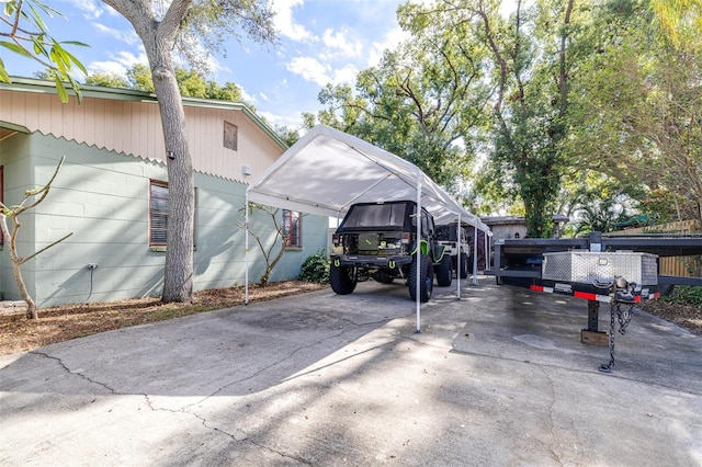 view of parking / parking lot with concrete driveway