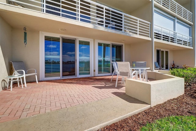 view of patio featuring outdoor dining space and a balcony