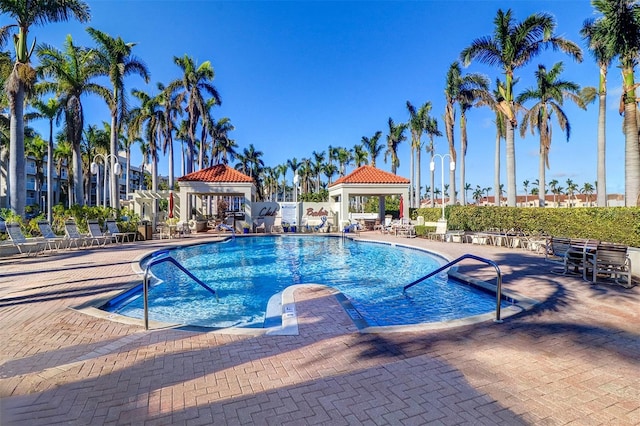 pool with a patio and a gazebo