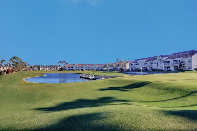 view of property's community with a residential view, a water view, and a yard