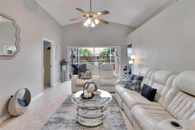 living area featuring ceiling fan, high vaulted ceiling, light tile patterned flooring, and baseboards