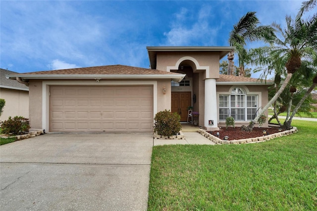 view of front of property with a front lawn, an attached garage, and stucco siding