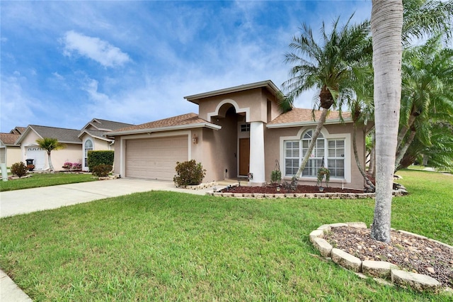 view of front of house featuring a front yard, concrete driveway, an attached garage, and stucco siding