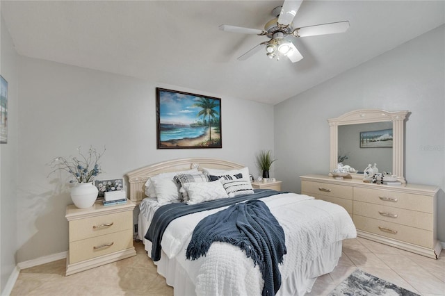 bedroom with baseboards, vaulted ceiling, a ceiling fan, and light tile patterned flooring