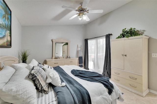 bedroom featuring ceiling fan, baseboards, and light tile patterned flooring