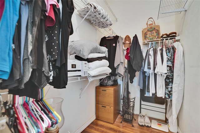 spacious closet with wood finished floors